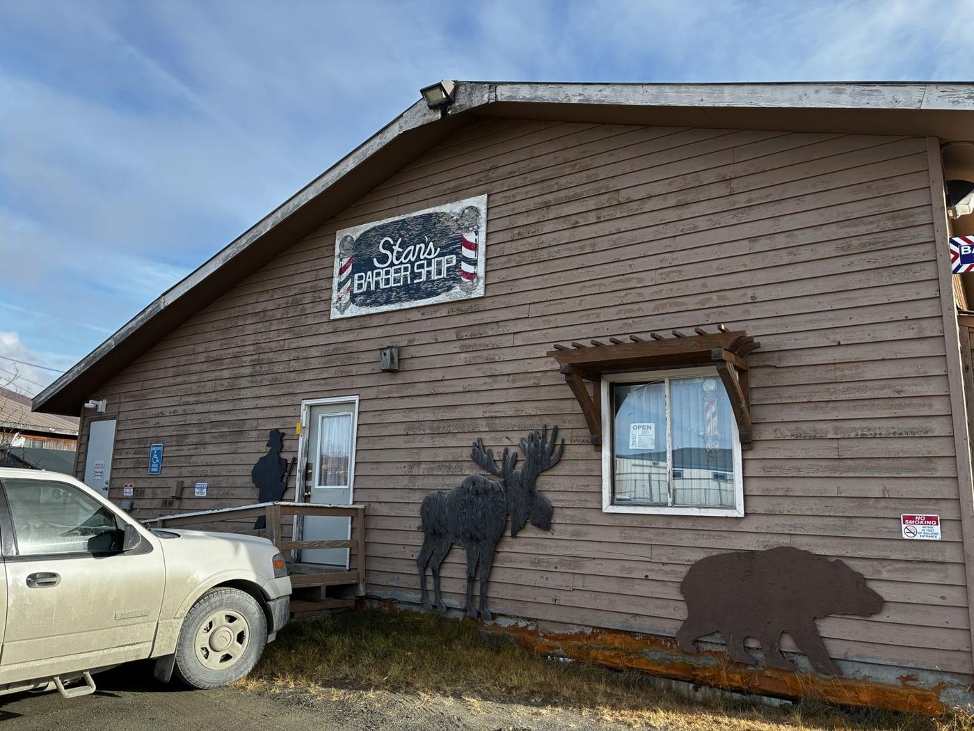 The hand-painted Stan's Barber Shop sign on the building